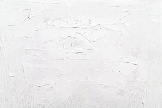 person repairing their garage floor with epoxy paint