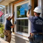 Professional contractors installing ENERGY STAR energy-efficient window replacement in a veteran’s suburban home during daytime renovation work